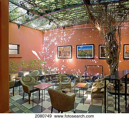 Stock Photo - Cafe Interior With Sunlight Through The Vines Playing On The Walls; Mendoza Argentina. Fotosearch