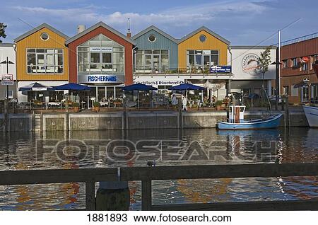 Stock Image - Cafes And Colorful Houses Along Harbor. Fotosearch