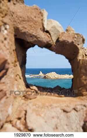 Stock Image - Cala Pregonda As Seen Through The Rocks, Menorca, Balearic Islands, Spain. Fotosearch