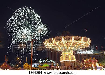Calgary, Alberta, Canada; Midway Rides At Night With Fireworks At The Calgary Stampede View Large Photo Image Picture - Calgary, Alberta, Canada; Midway Rides At Night With Fireworks At The Calgary Stampede. Fotosearch
