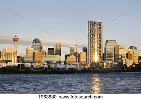 Stock Image - Calgary Skyline At Sunrise Along The Bow River; Calgary Alberta Canada. Fotosearch