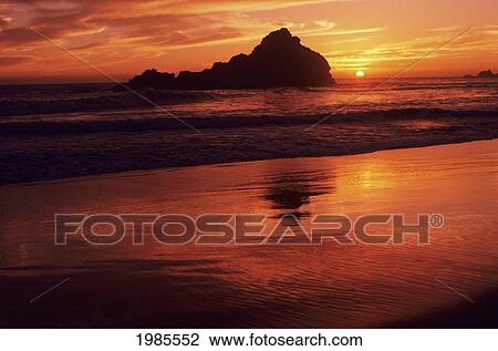 Stock Image - California, Big Sur Coast, Gorgeous Red Sunset Over Beach And Ocean.. Fotosearch