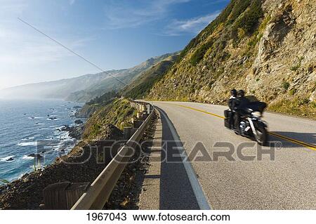 Stock Image - California, Big Sur, Coastal Shot Of Highway 1 With Motorcycle Driving. Fotosearch