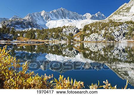 Stock Photo - California, Eastern Sierras, Beautiful Mountain Lake Scene With Dramatic Snowy Peaks. Fotosearch