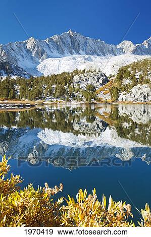 California, Eastern Sierras, Beautiful Mountain Lake Scene With Dramatic Snowy Peaks View Large Photo Image Stock Photo - California, Eastern Sierras, Beautiful Mountain Lake Scene With Dramatic Snowy Peaks. Fotosearch