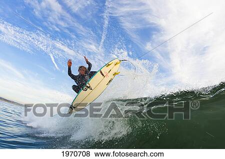 Stock Photo - California, Huntington Beach, Surfer Catches Air On A Fun Playful Wave. For Editorial Use Only.. Fotosearch