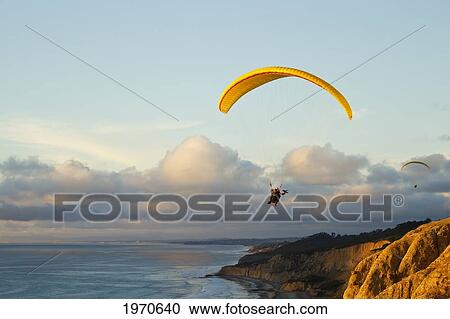 Stock Image - California, La Jolla, Paragliders Flying Over The Coast. For Editorial Use Only.. Fotosearch