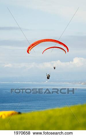 Stock Photo - California, La Jolla, Paragliders Flying Over The Coast. For Editorial Use Only.. Fotosearch