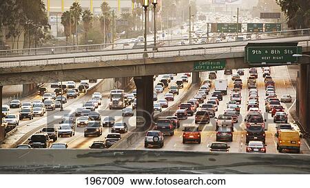 Stock Photo - California, Los Angeles, Freeway Traffic In Downtown La At Sunset. Fotosearch