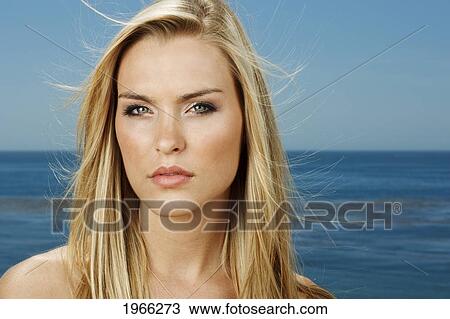 Stock Image - California, Malibu, Portrait Of Beautiful Blond Woman, Blue Ocean In Background.. Fotosearch