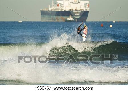 California, Manhattan Beach, Surfer Carving A Big Powerful Turn View Large Photo Image Stock Photo - California, Manhattan Beach, Surfer Carving A Big Powerful Turn. Fotosearch