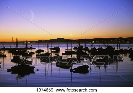Stock Photo - California, Monterey Bay, Fishing Boats Silhouetted Against Sunset, Crescent Moon.. Fotosearch