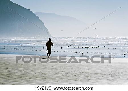 California, Morro Bay, Silhouette Of Man Jogging On Beach. View Large Photo Image Stock Photo - California, Morro Bay, Silhouette Of Man Jogging On Beach.. Fotosearch