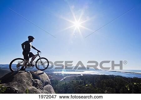 California, Morro Bay State Park, Man On Bicycle Looks Over Morro Bay From Cliff. View Large Photo Image Stock Photo - California, Morro Bay State Park, Man On Bicycle Looks Over Morro Bay From Cliff.. Fotosearch