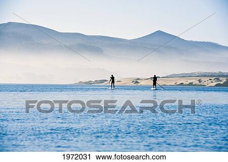 California, Morro Bay State Park, Two People Stand Up Paddleboard In Ocean. View Large Photo Image Stock Image - California, Morro Bay State Park, Two People Stand Up Paddleboard In Ocean.. Fotosearch