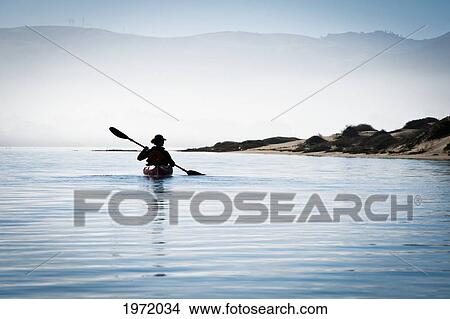 Picture - California, Morro Bay State Park, Woman Kayaking In Ocean, Silhouette.. Fotosearch
