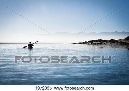 Stock Photography - California, Morro Bay State Park, Woman Kayaking In Ocean, Silhouette.. Fotosearch