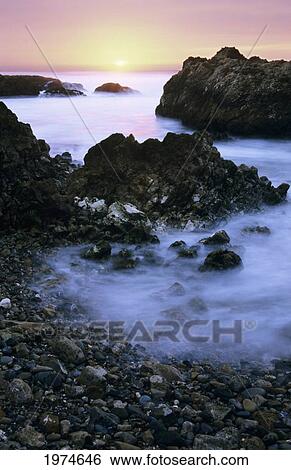 Stock Photograph - California, Pescadero, Beautiful Sunset Along Coast, Misty Ocean Along Shore, Long Exposure.. Fotosearch