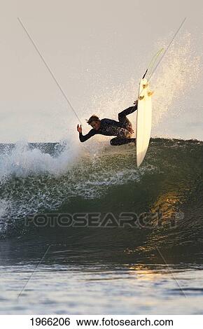 Stock Photograph - California, San Clemente, Surfer Carving Wave, Evening Light. Editorial Use Only.. Fotosearch