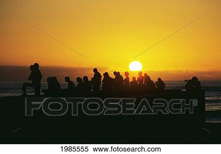 California, Santa Monica, Silhouetted People Observing Beautiful Sunset Over Ocean. View Large Photo Image Stock Photography - California, Santa Monica, Silhouetted People Observing Beautiful Sunset Over Ocean.. Fotosearch