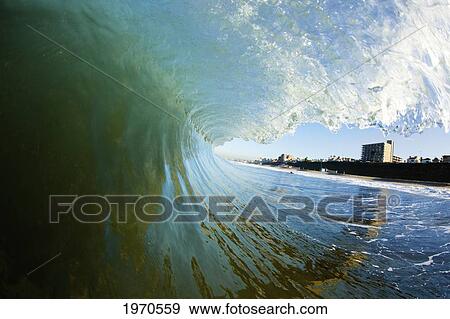 Stock Photo - California, Ventura, Shore Framed By A Big Breaking Wave. Fotosearch