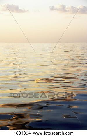 Calm Sea Surface With Sunset, Low Angle View View Large Photo Image Picture - Calm Sea Surface With Sunset, Low Angle View. Fotosearch