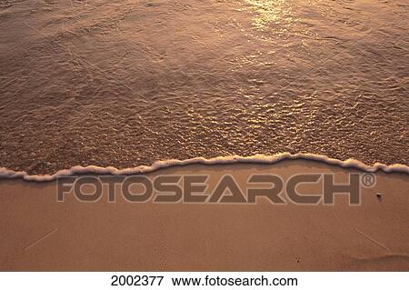 Calm Water Washing Onto Sandy Beach, Sunrise Reflections View Large Photo Image Stock Photo - Calm Water Washing Onto Sandy Beach, Sunrise Reflections. Fotosearch
