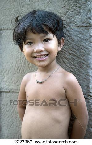 Cambodia, Angkor Wat, Young Girl Standing Against Temple Wall View Large Photo Image Stock Photo - Cambodia, Angkor Wat, Young Girl Standing Against Temple Wall. Fotosearch