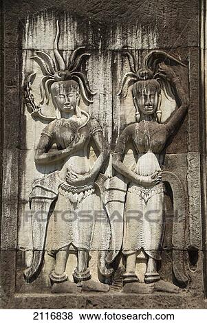 Stock Photo - Cambodia, Siem Reap, Angkor Wat, Angkor Archaeological Park, Carvings in exterior of building.. Fotosearch