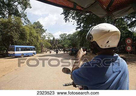 Cambodia, Tuk Tuk driver approaching gate to Bayon Temple; Angkor Wat View Large Photo Image Stock Image - Cambodia, Tuk Tuk driver approaching gate to Bayon Temple; Angkor Wat. Fotosearch