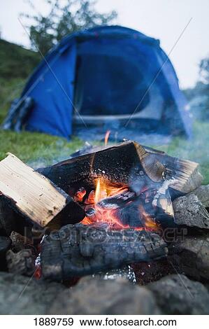 Stock Photo - Campfire Coal Smoldering Infront Of Tent, Low Angle View. Fotosearch