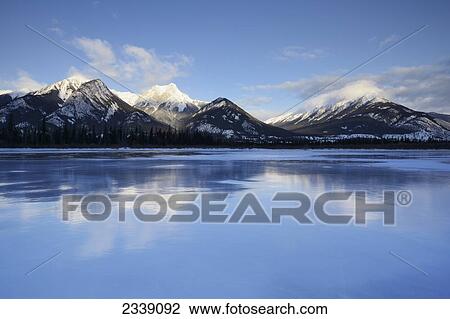 Canadian Rockies And Lake In Jasper National Park; Alberta, Canada View Large Photo Image Stock Image - Canadian Rockies And Lake In Jasper National Park; Alberta, Canada. Fotosearch