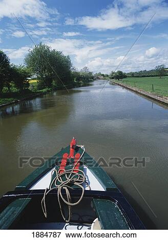 Stock Photo - Canal Boat Going Down The Grand Union Canal. Fotosearch
