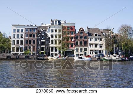 Canal Houses By The Amstel River, Amsterdam, Netherlands View Large Photo Image Stock Image - Canal Houses By The Amstel River, Amsterdam, Netherlands. Fotosearch