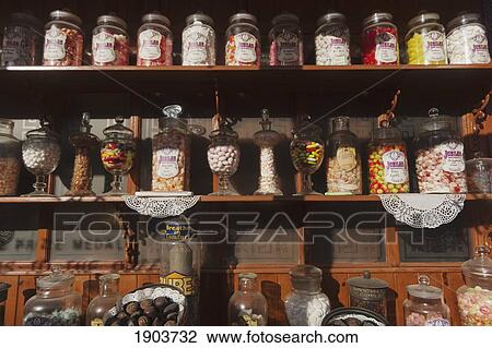 Stock Image - Candies In Jars Displayed On A Shelf; Beamish, Durham, England. Fotosearch