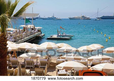 Cannes, Provence, France; Beach Umbrellas On The Shore And Boats In The Water View Large Photo Image Stock Photo - Cannes, Provence, France; Beach Umbrellas On The Shore And Boats In The Water. Fotosearch