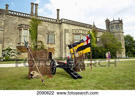 Stock Image - Cannon And Tourists In Front Of Lacock Abbey, Lacock, Wiltshire, Uk. Fotosearch