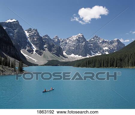 Stock Image - Canoeing On Moraine Lake, Banff National Park; Alberta, Canada. Fotosearch