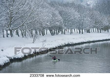 Canoeist going down the River Ouse in snowy conditions; Lewes, East Sussex, England View Large Photo Image Stock Photo - Canoeist going down the River Ouse in snowy conditions; Lewes, East Sussex, England. Fotosearch