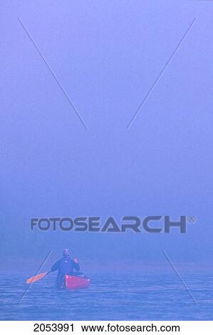 Stock Image - Canoeist Paddling In Fog, Peel River, Whitehorse, Yukon. Fotosearch