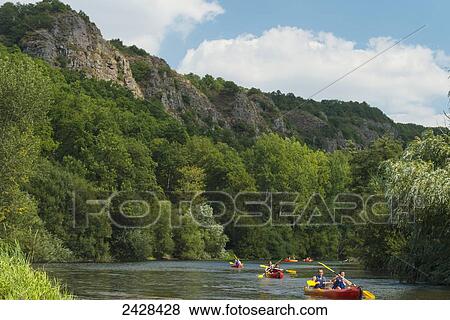 Stock Photo - Canoeists paddling along L'Orne River; Clecy, Swiss Normandy, Normandy, France. Fotosearch