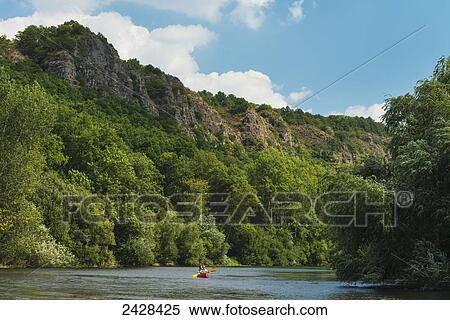 Stock Photography - Canoeists paddling along L'Orne River; Clecy, Swiss Normandy, Normandy, France. Fotosearch