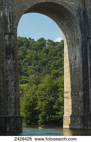 Canoeists paddling beneath the Viaduct de Clecy along L'Orne River; Clecy, Swiss Normandy, Normandy, France View Large Photo Image Stock Photograph - Canoeists paddling beneath the Viaduct de Clecy along L'Orne River; Clecy, Swiss Normandy, Normandy, France. Fotosearch