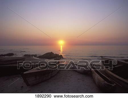 Stock Image - Canoes And Fishing Boats On Beach By Lake Malawi, Sunset. Fotosearch