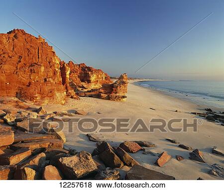 Stock Photo - Cape Leveque glowing red at sunset; Kimberley Region, Australia. Fotosearch