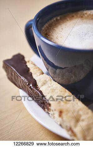 Cappuccino and chocolate dipped biscotti on a white plate; Ontario, Canada View Large Photo Image Stock Photo - Cappuccino and chocolate dipped biscotti on a white plate; Ontario, Canada. Fotosearch