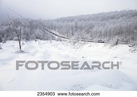 Stock Image - Car On Olde Base Line Road In Snowy Winter By Cheltenham Badlands; Caledon, Ontario, Canada. Fotosearch