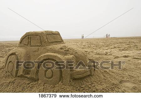 Stock Photo - Car Sand Sculpture, Pacific City; Pacific City, Oregon, Usa. Fotosearch