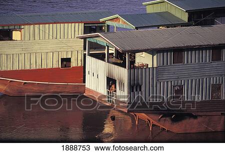 Stock Image - Cargo Boats On The Mekong River. Fotosearch