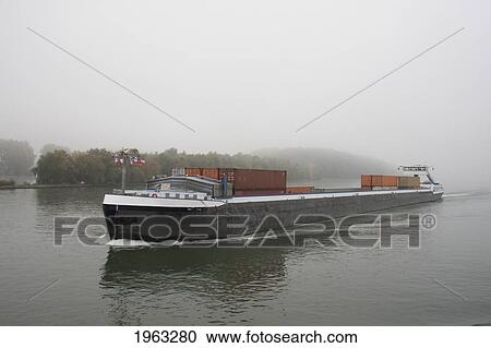Cargo Container Ship On The Mainz River In The Fog, Mainz, Rhineland-Palatinate, Germany View Large Photo Image Stock Image - Cargo Container Ship On The Mainz River In The Fog, Mainz, Rhineland-Palatinate, Germany. Fotosearch